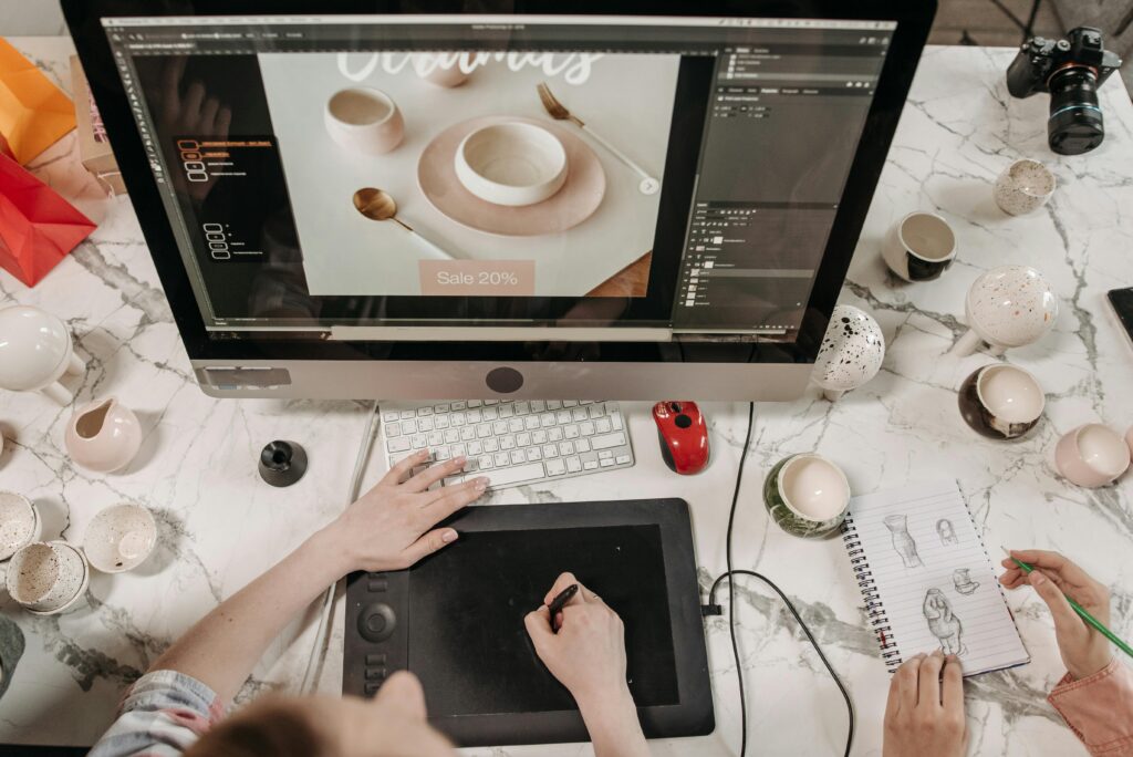 Overhead view of a creative workspace with design tools and sketches visible, ideal for teamwork and collaboration.